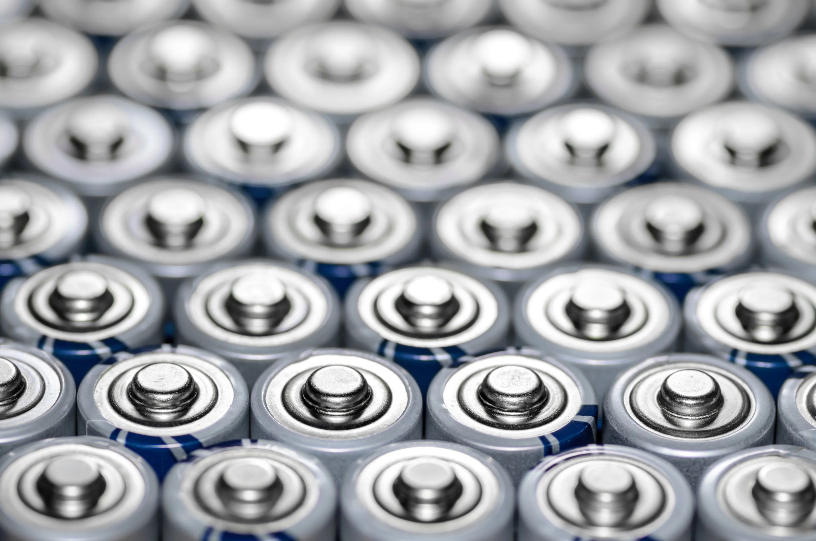 Rows of used cylindrical batteries awaiting recycling